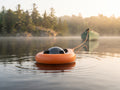 AI-generated illustration: Sonar Life Jacket towed behind a canoe on a misty lake